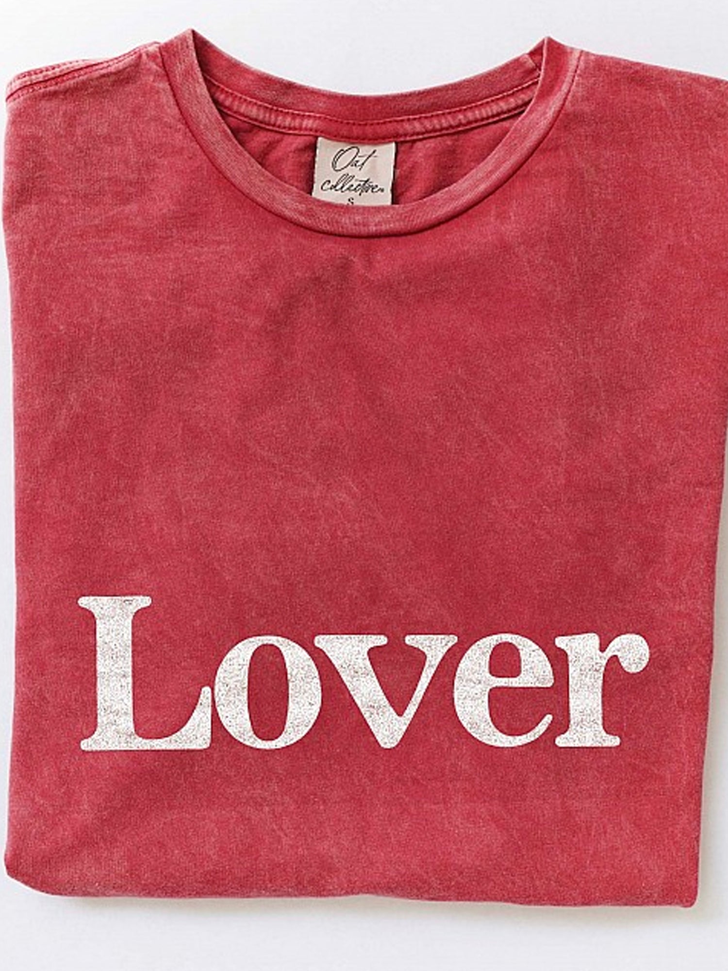 Red folded t-shirt featuring the word "Lover" in white text.