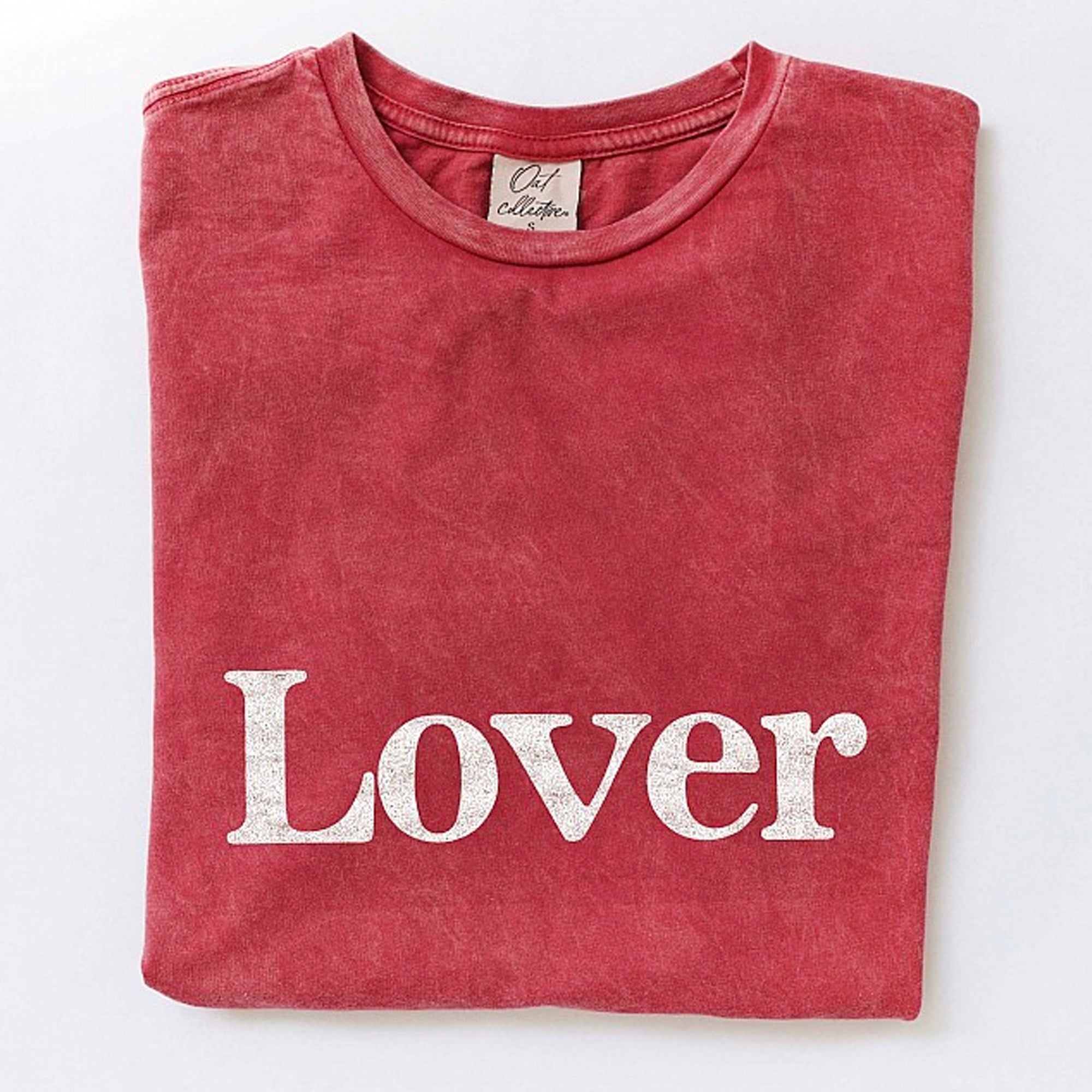 Red folded t-shirt featuring the word "Lover" in white text.