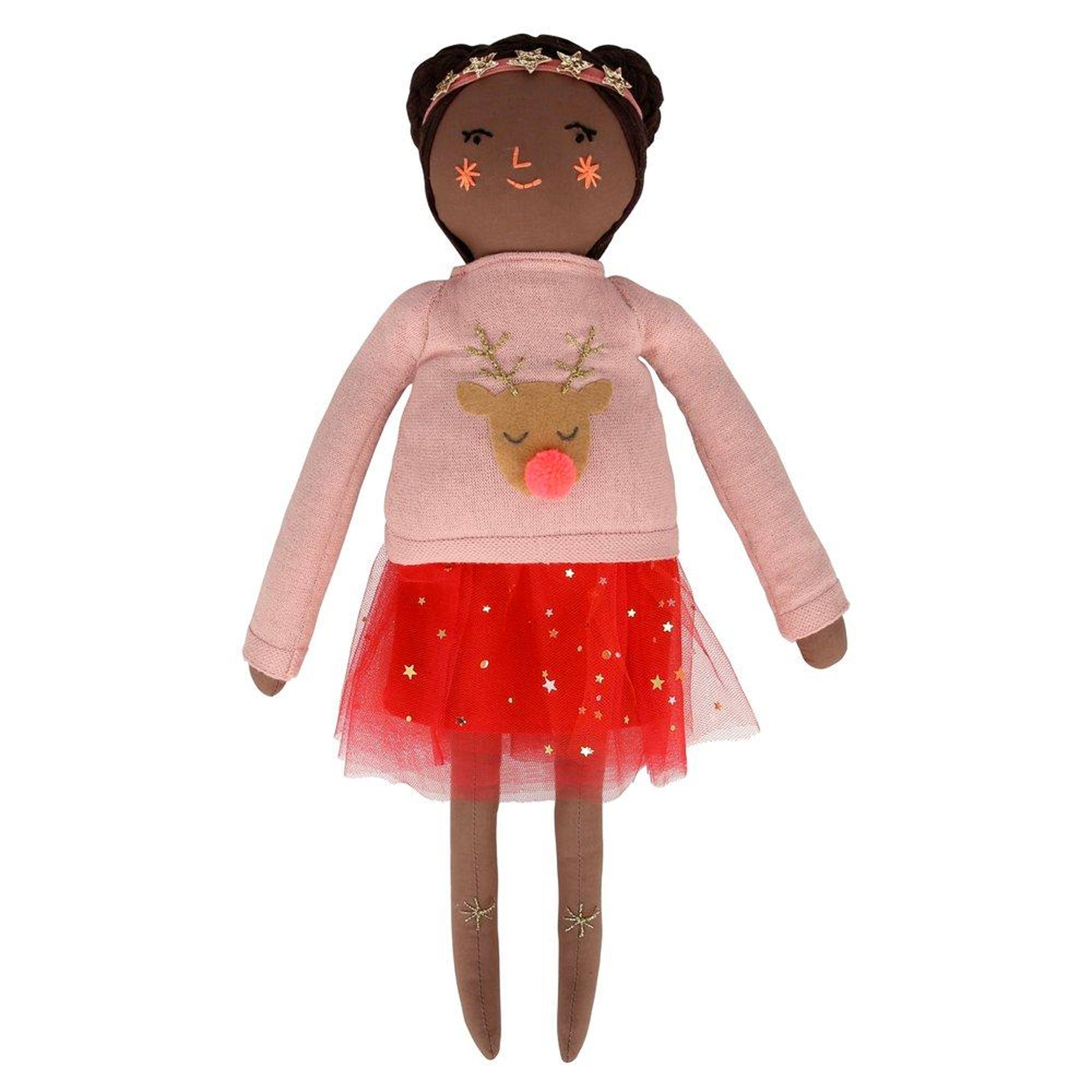Doll with brown skin, wearing a pink sweater with reindeer design and a red tulle skirt, adorned with stars.