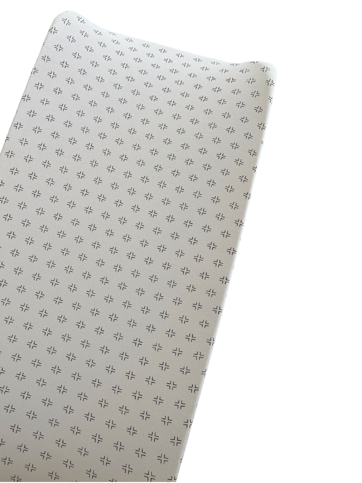 Textured fabric surface with small patterned designs on a light background. Ideal for soft furnishings or upholstery.
