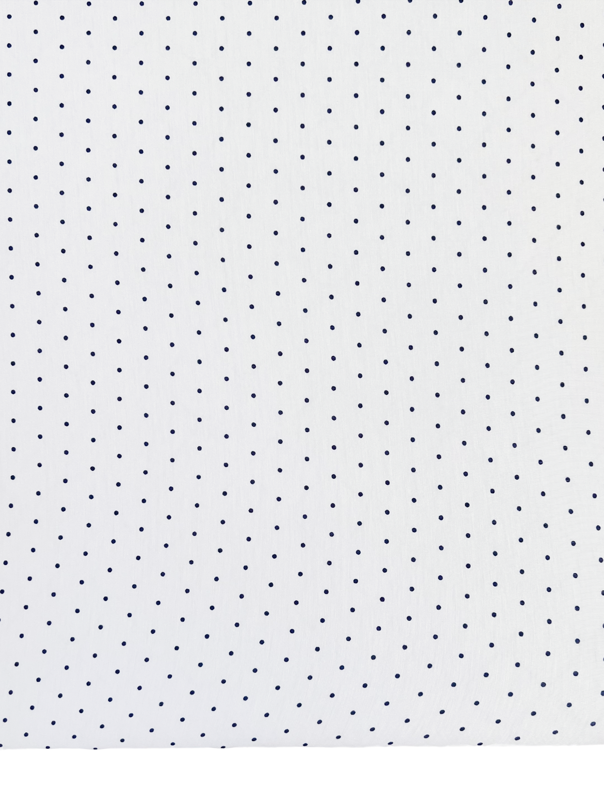White fabric with small navy blue polka dots, ideal for home decor or textiles.