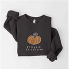 Dark sweatshirt with "pumpkin spice latte" text and orange pumpkin graphic. Cozy fall fashion piece.