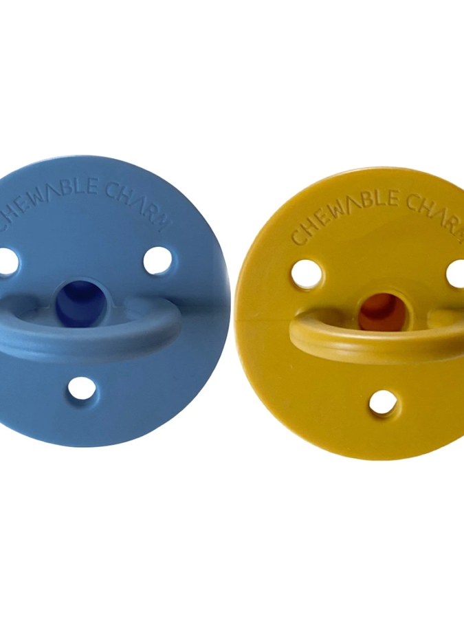 Two colorful chewable charms, one blue and one yellow, designed for sensory play and oral stimulation.