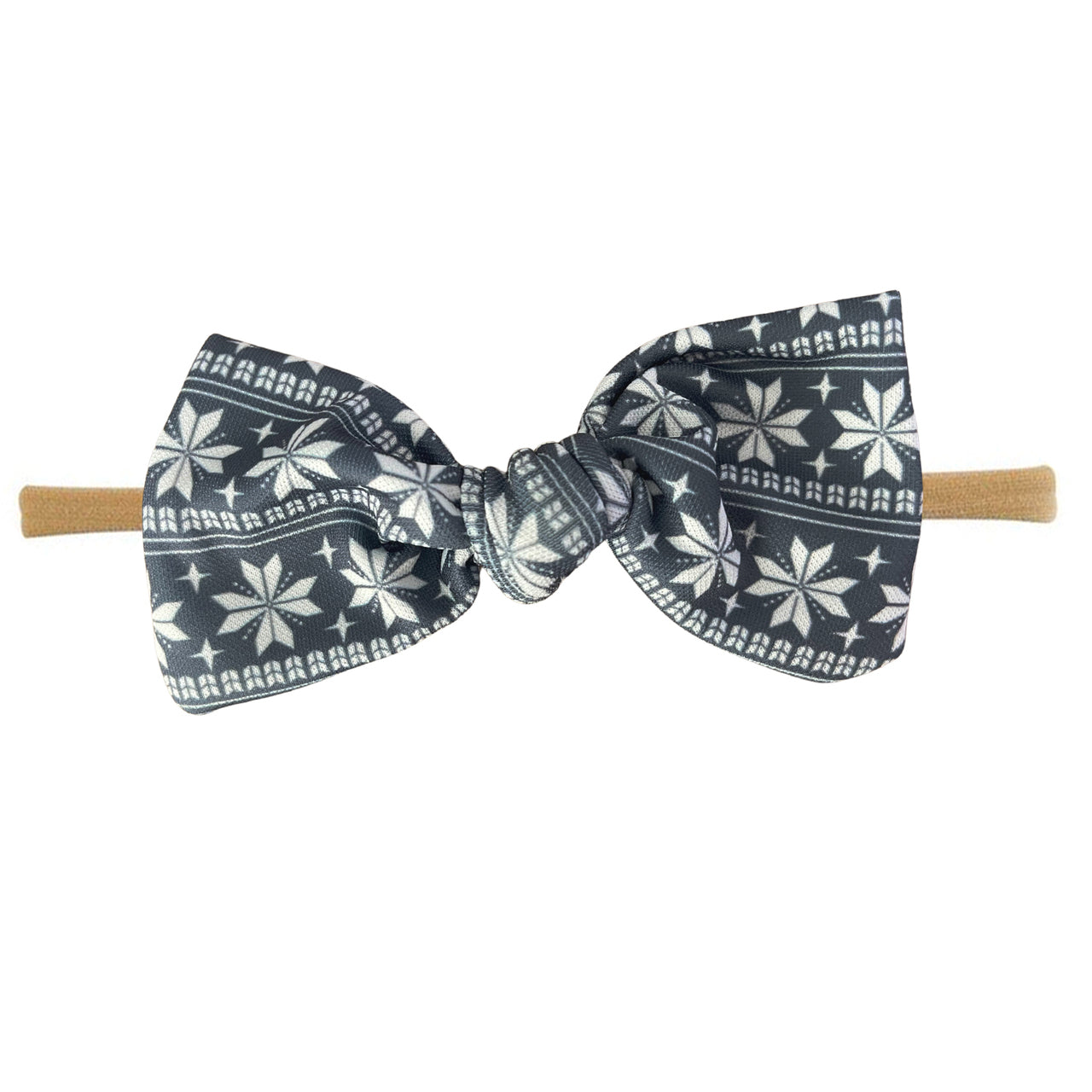 Navy blue bow tie with white floral patterns on a beige elastic band.