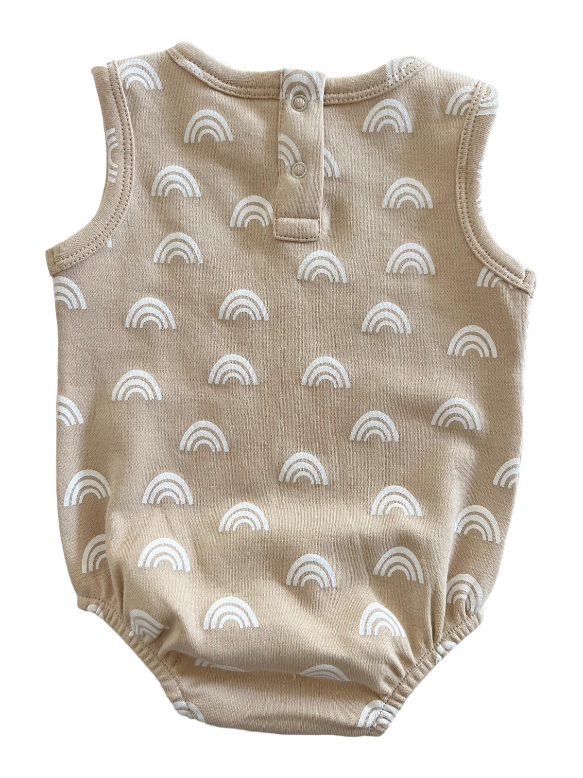 Tan baby romper with white rainbow prints and snap closure at the back. 
