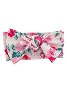 Floral headband with a large bow, featuring pink and green roses on a light background. 