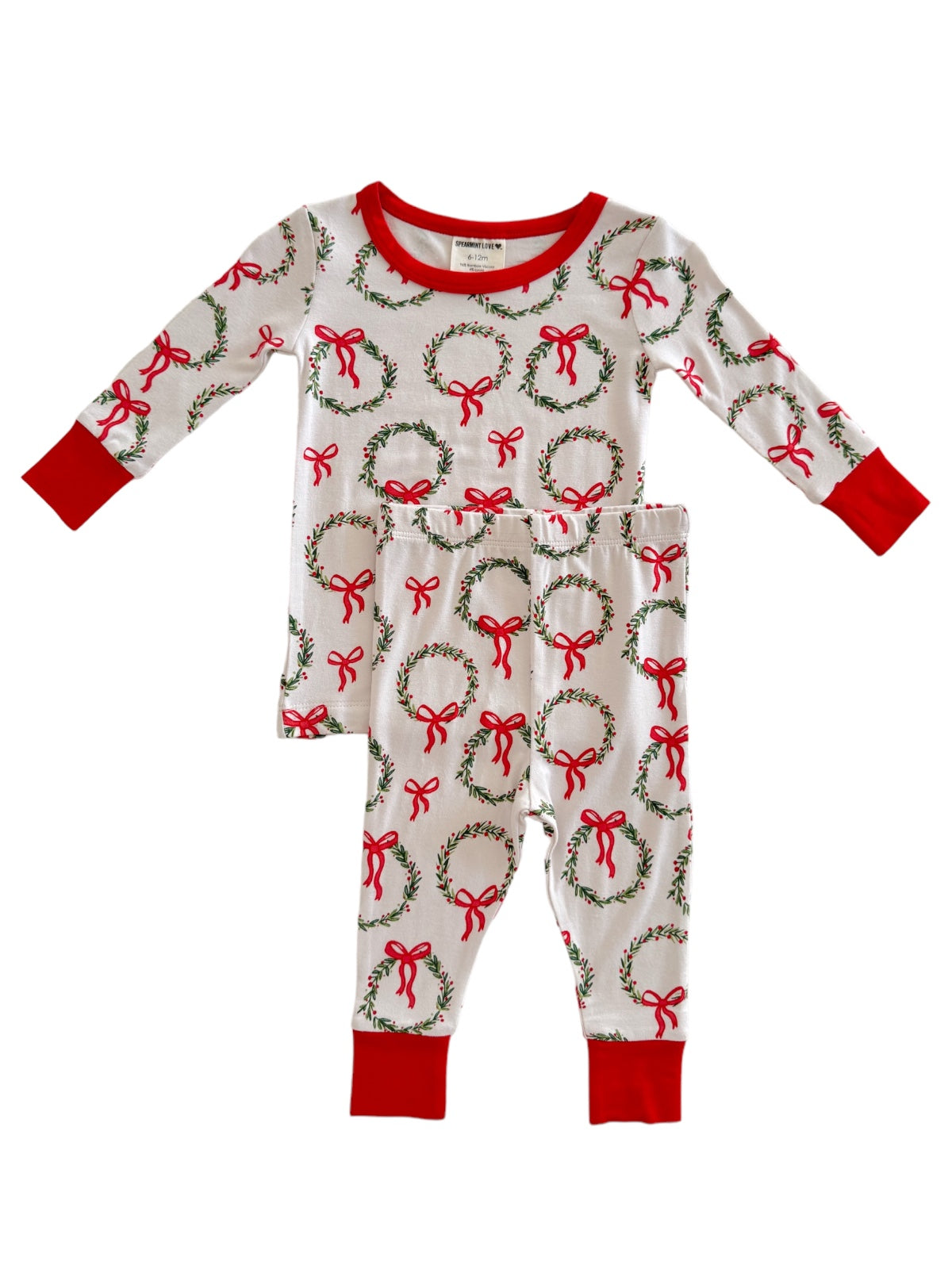 White pajama set featuring red and green wreaths with bows, perfect for festive occasions.