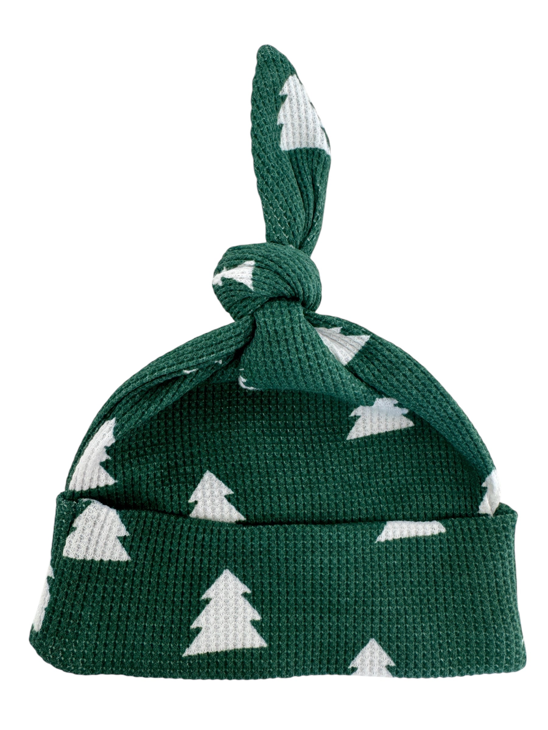 Green knit hat with white Christmas trees and a knotted top.