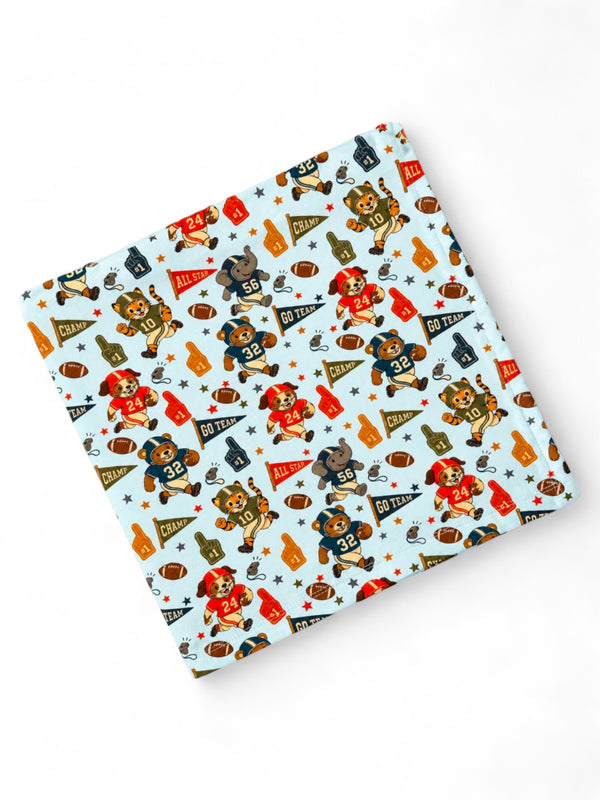Patterned fabric featuring playful sports-themed cartoon animals and vibrant team colors. Perfect for kids' items.