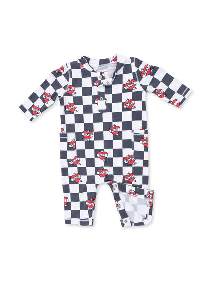 Black and white checkered baby romper with red heart patches labeled "MOM" and "DAD".