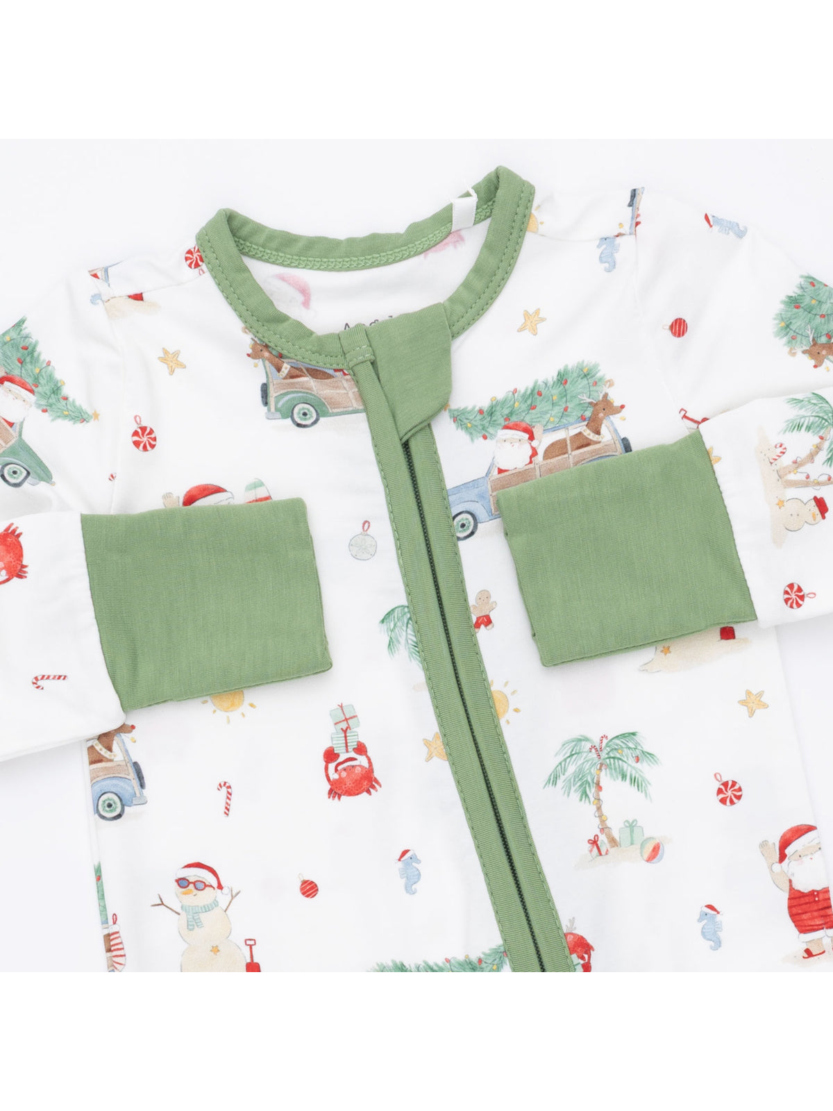 Baby onesie with festive prints, green trim, and zipper closure featuring Santa, trees, and holiday icons.