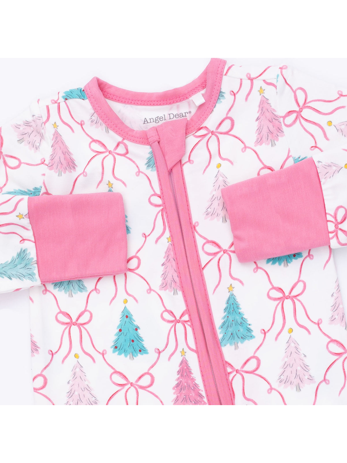 Pink and white children's pajamas featuring colorful Christmas tree patterns and bows.