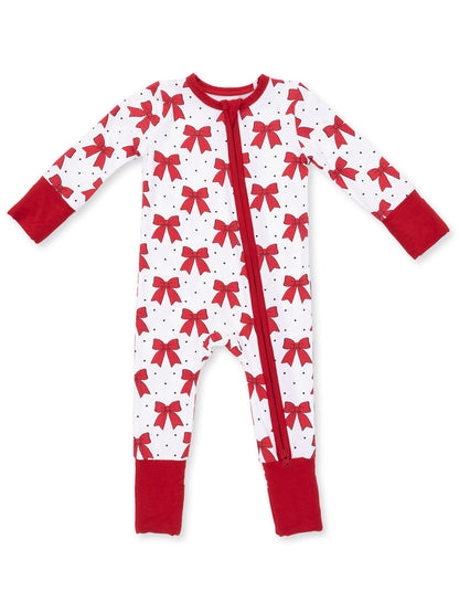 Red and white baby onesie with bow pattern and zipper, perfect for sleepwear or festive occasions.