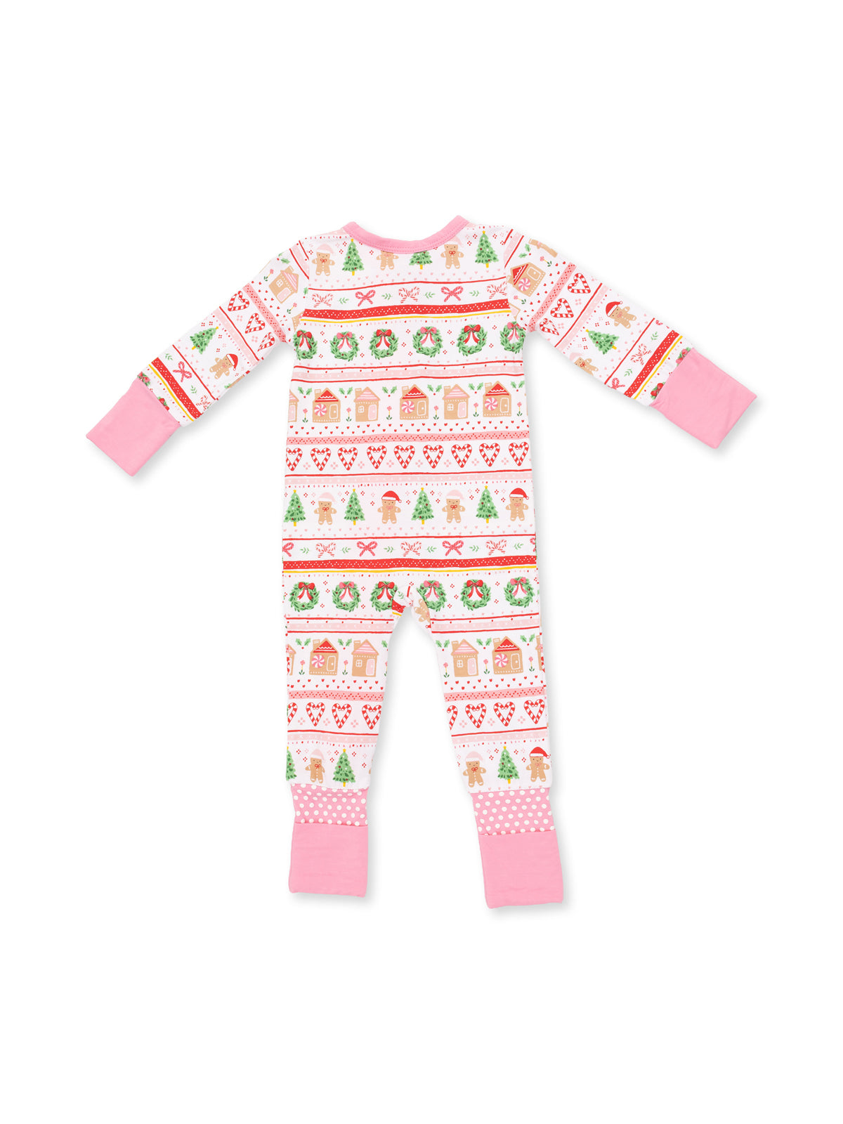 Colorful children's pajamas featuring holiday patterns of trees, gingerbread, and hearts, with pink sleeves and legs.