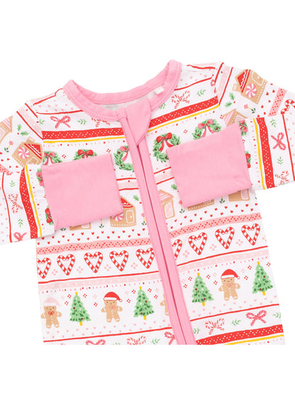 Pink pajama with holiday patterns, featuring gingerbread men, candy canes, and Christmas trees.