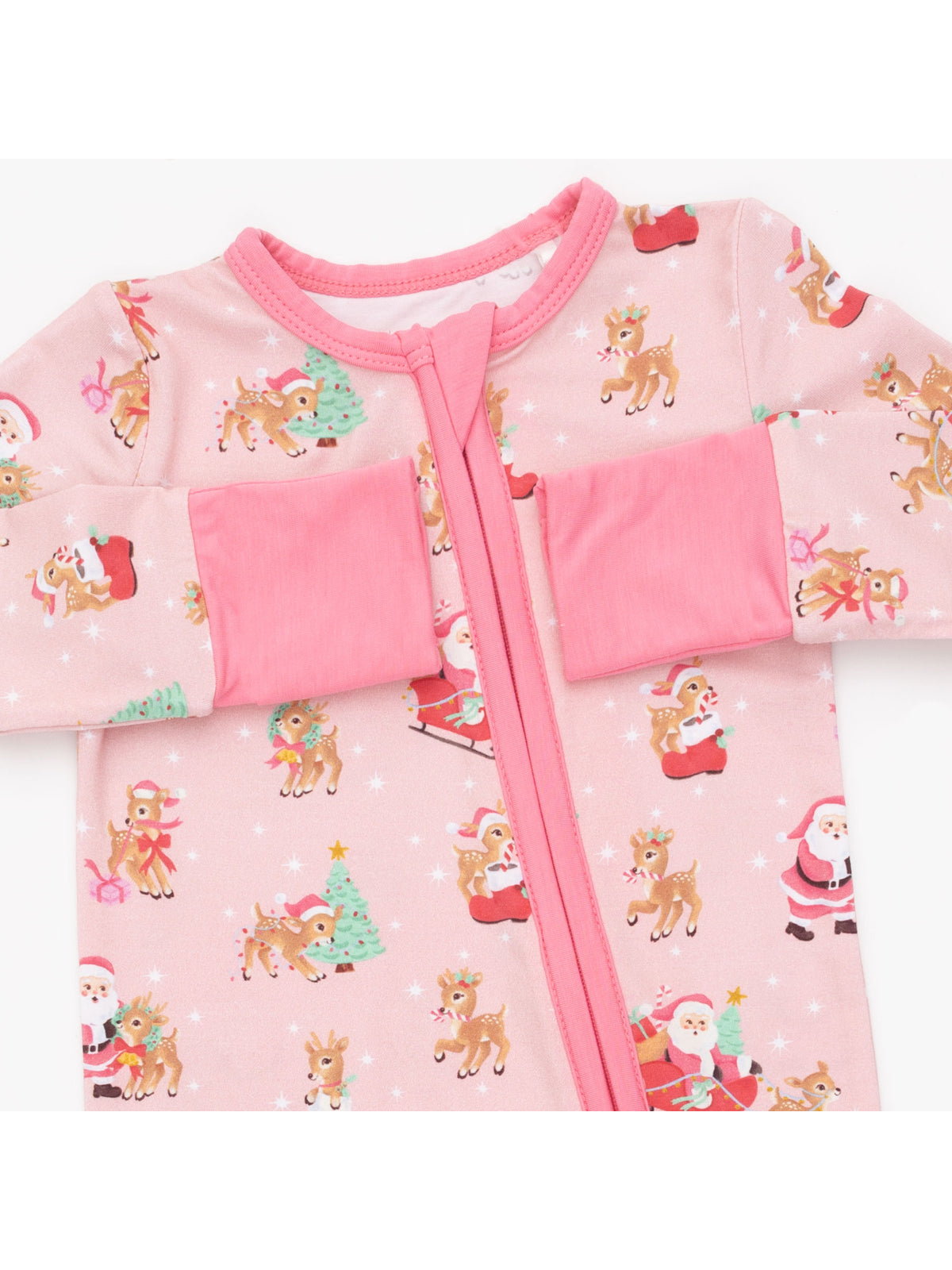 Pink holiday onesie featuring reindeer, Santa, and Christmas trees in playful patterns. Ideal for festive occasions.
