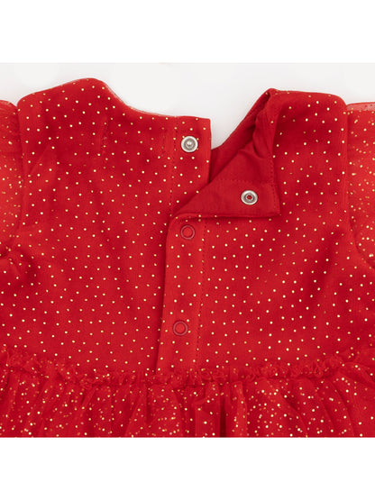 Red dress with gold polka dots, featuring snap buttons and sheer ruffled skirt.
