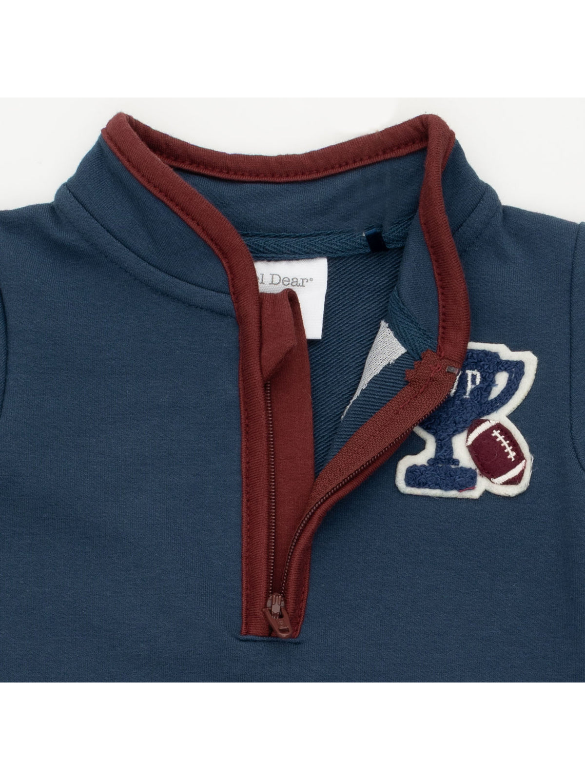 Navy blue sweatshirt collar with maroon trim and a football-themed embroidered patch.