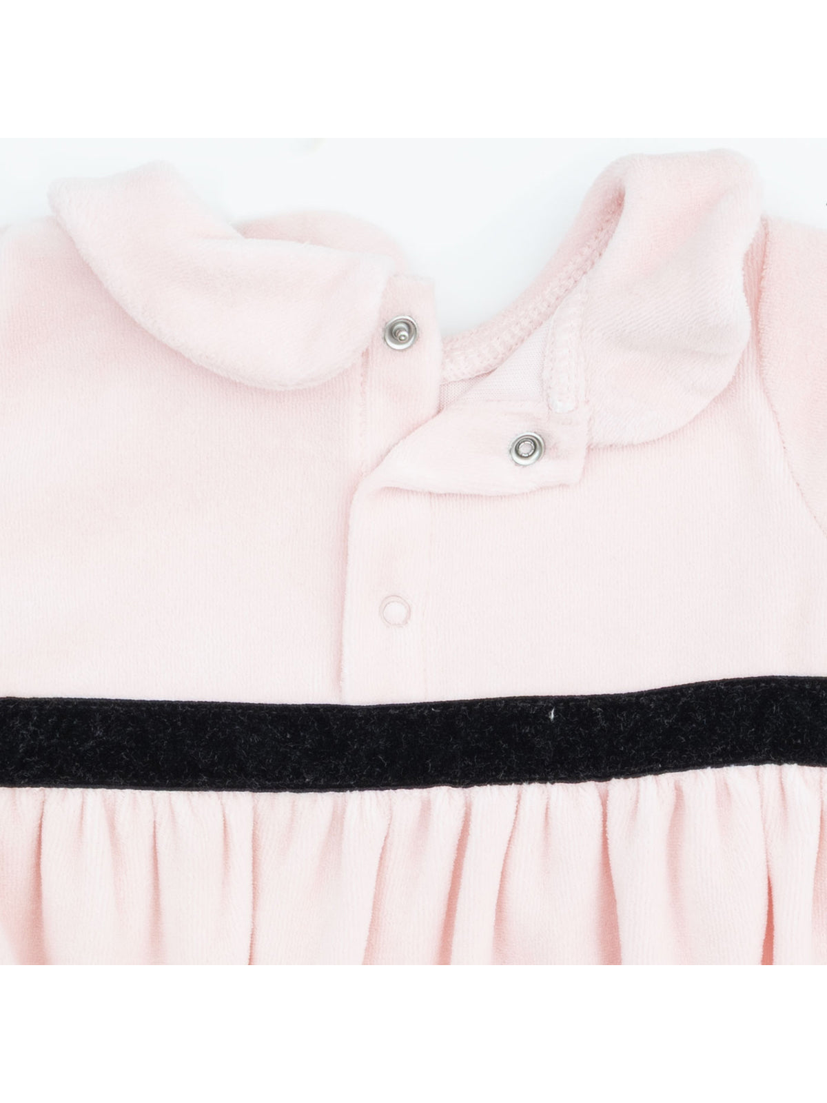 Light pink dress with a collar and black waistband detail, featuring snap closures at the neckline.