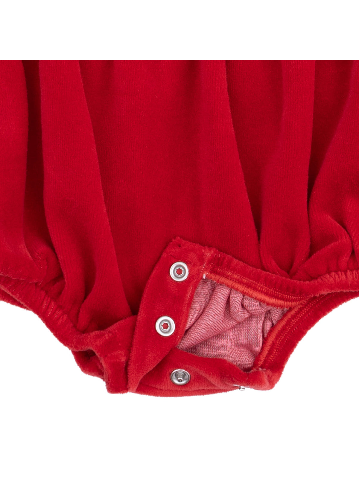 Red baby romper with snap closures at the bottom, showcasing soft fabric texture.