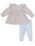 Floral top with ruffles paired with light blue leggings for a cute toddler outfit.