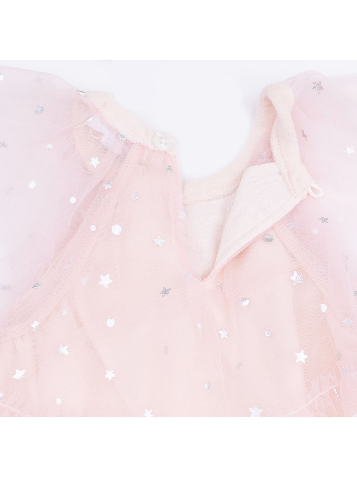 Light pink dress with silver stars and ruffled tulle, featuring a button closure at the neckline.