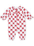 White baby romper with red bows and polka dot pattern, featuring gathered sleeves and collar.