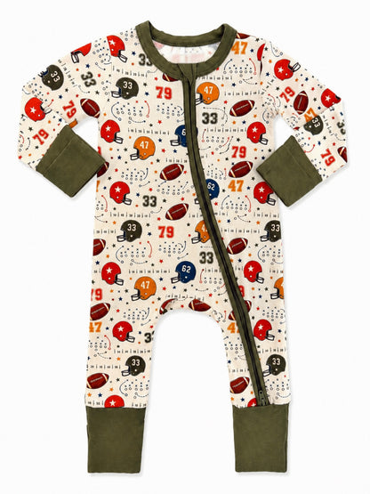 Football-themed infant onesie with colorful helmets and numbers on a cream background, featuring a front zipper.