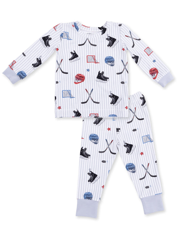 Kids' hockey-themed pajamas with hockey sticks, skates, and helmets on a striped background. Perfect for young fans.