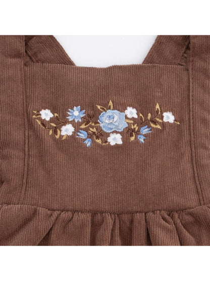 Brown corduroy fabric featuring blue and white floral embroidery.