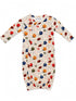 Infant football-themed sleeper with colorful helmet and ball prints on a cream background. Ideal for young sports fans.