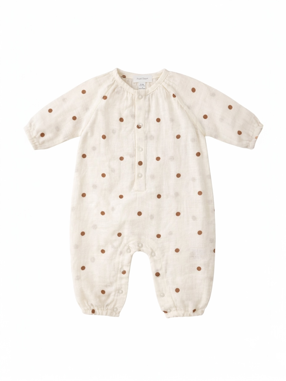 Cream-colored baby romper with brown polka dots and button closure, featuring long sleeves and snap bottom.