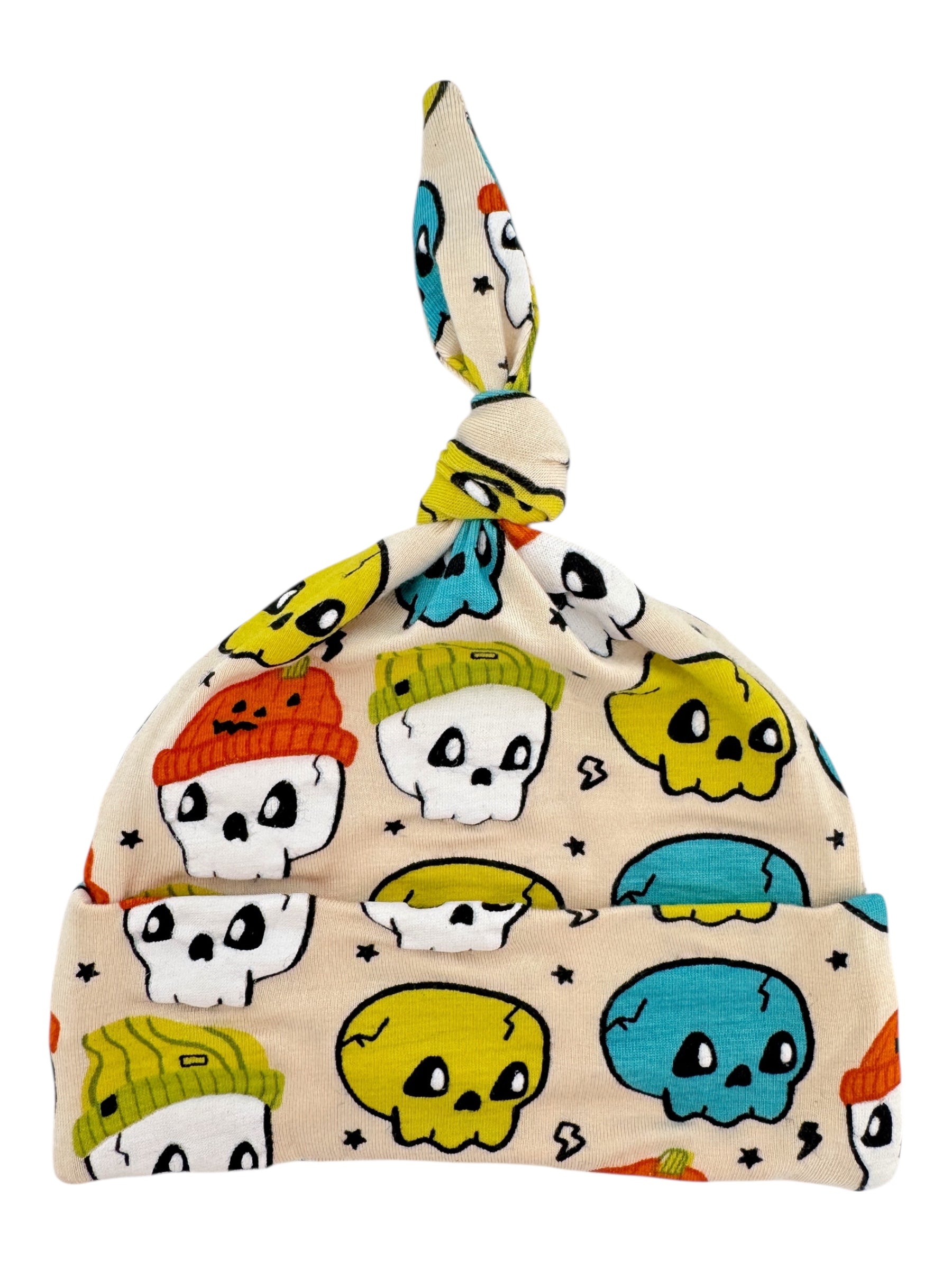 Colorful skull-patterned baby hat with a knot on top, featuring playful designs in various colors.