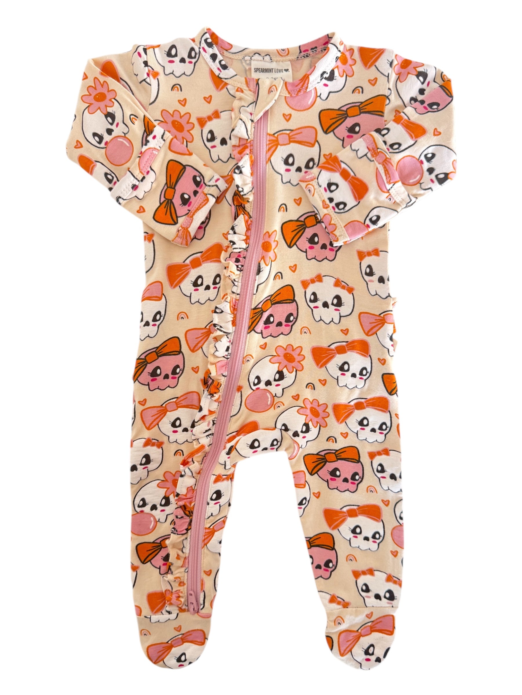 Cute baby onesie with colorful skull and bow patterns, featuring a front zipper and ruffle details.