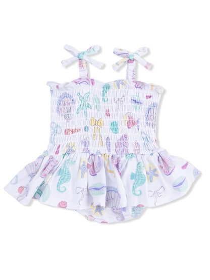 White romper with colorful sea-themed prints and bows on shoulder straps, ideal for summer wear.