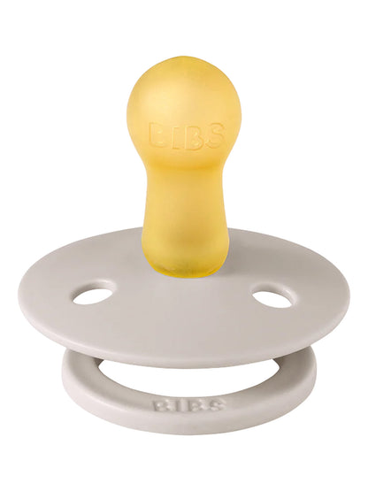 Yellow rubber pacifier with a gray silicone shield, featuring the brand name "BIBS" embossed on the handle.