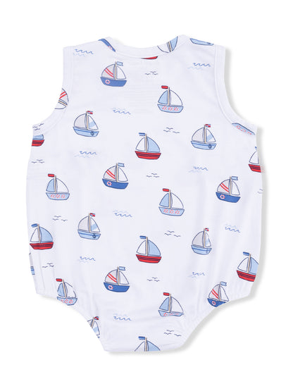 White baby romper with a print of colorful sailboats and waves, featuring sleeveless design.