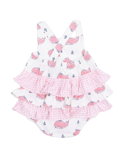 Pink whale-patterned baby romper with ruffled layers and crossback straps. Ideal for summer outfits.
