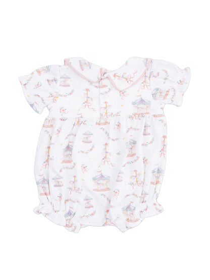 White baby romper with colorful carousel print and ruffled sleeves, featuring a pink collar and gathered bottom.