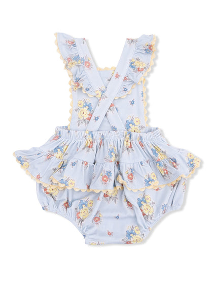 Floral baby romper in light blue with ruffled sleeves and skirt, featuring yellow scalloped trim. Perfect for summer.