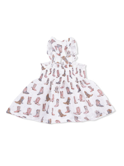 White dress with a ruffled neckline, featuring a colorful cowboy boot pattern. Ideal for casual summer wear.