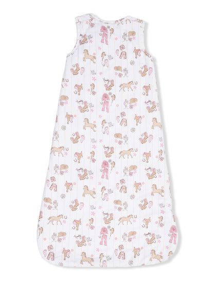 Baby sleep sack with playful horse and grooming-themed patterns in pastel colors on a white background.