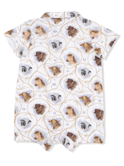 Children's romper featuring a playful pattern of animal heads including cows and horses on a light background.