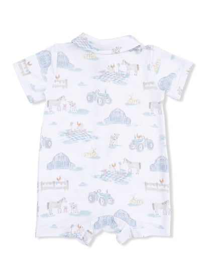 White baby romper featuring a farm animal print with tractors, barns, and playful designs in soft colors.
