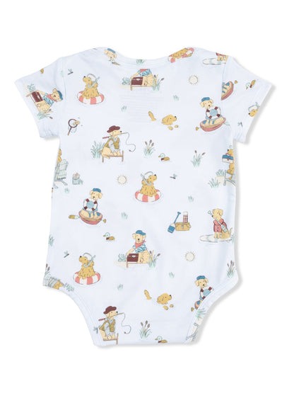Light blue baby onesie featuring playful, cartoon dogs engaged in various outdoor activities.