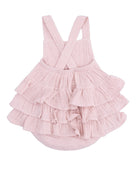 Light pink tiered dress with cross-back straps, featuring soft ruffles for a playful and stylish look.