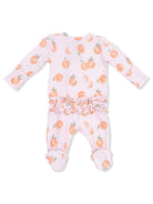 Pink baby onesie with peach pattern and ruffled waist, featuring footed design with polka dot soles.