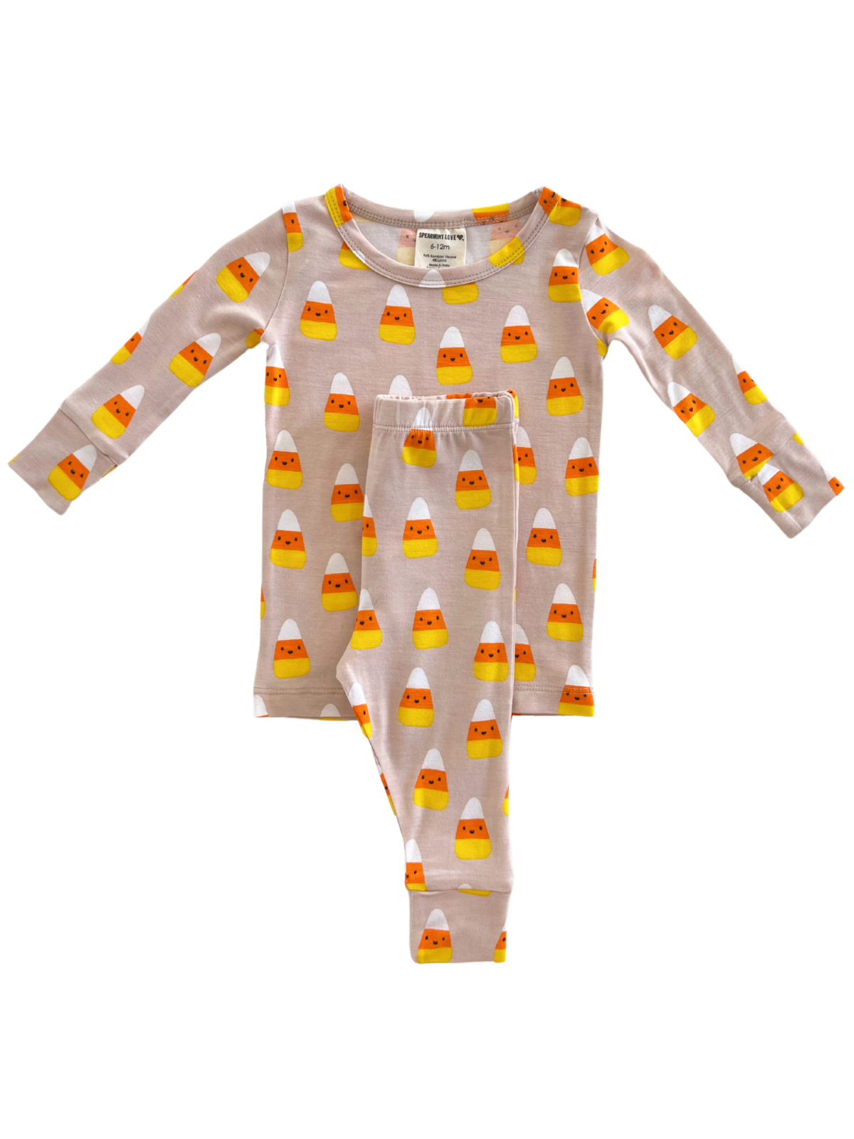 Children's pajama set with candy corn pattern on a light background, featuring long sleeves and pants.
