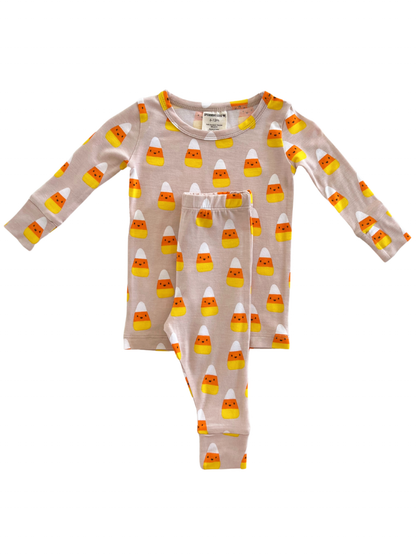 Children's pajama set with candy corn pattern on a light background, featuring long sleeves and pants.