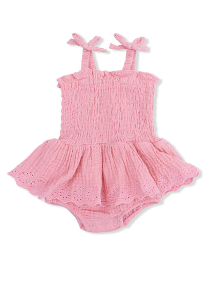 Pink baby romper with straps and ruffled skirt, featuring embroidered details at the hem. Ideal for warm weather.